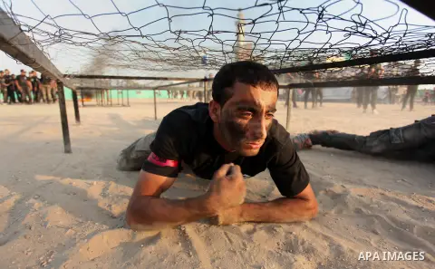 Palestinian youths demonstrate their skills during a military-style exercise at the Liberation Youths summer camp, organised by the Hamas movement, in Gaza city on July 20, 2016. Photo by Ashraf Amra