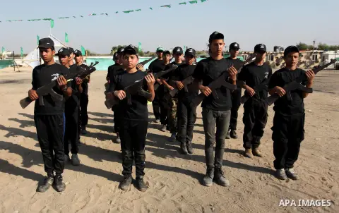 Palestinian youths demonstrate their skills during a military-style exercise at the Liberation Youths summer camp, organised by the Hamas movement, in Gaza city on July 20, 2016. Photo by Ashraf Amra