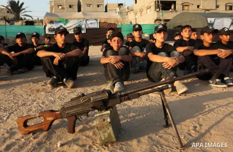 Palestinian youths take part in a military-style exercise at the Liberation Youths summer camp, organised by the Hamas movement, in Gaza city on July 20, 2016. Photo by Ashraf Amra