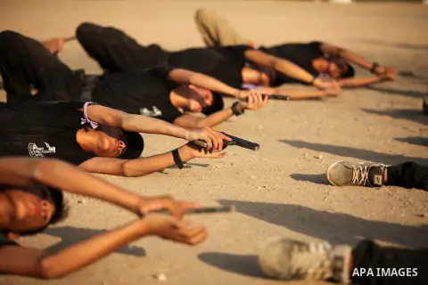 Palestinian youths demonstrate their skills during a military-style exercise at the Liberation Youths summer camp, organised by the Hamas movement, in Gaza city on July 20, 2016. Photo by Ashraf Amra