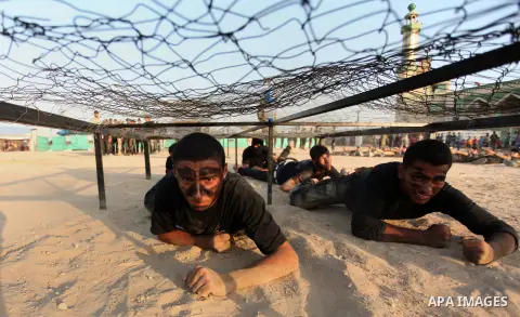 Palestinian youths demonstrate their skills during a military-style exercise at the Liberation Youths summer camp, organised by the Hamas movement, in Gaza city on July 20, 2016. Photo by Ashraf Amra