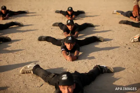Palestinian youths demonstrate their skills during a military-style exercise at the Liberation Youths summer camp, organised by the Hamas movement, in Gaza city on July 20, 2016. Photo by Ashraf Amra