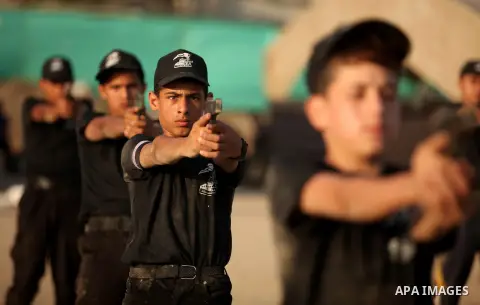 Palestinian youths demonstrate their skills during a military-style exercise at the Liberation Youths summer camp, organised by the Hamas movement, in Gaza city on July 20, 2016. Photo by Ashraf Amra