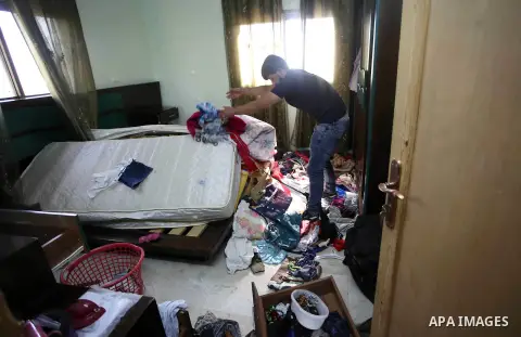 Palestinians inspect their room after the Israeli soldiers raided their family house, at Kafr Qalil village near the West Bank city of Nablus, on July 21, 2016. Photo by Nedal Eshtayah