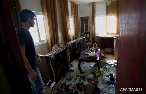 Palestinians inspect their room after the Israeli soldiers raided their family house, at Kafr Qalil village near the West Bank city of Nablus, on July 21, 2016. Photo by Nedal Eshtayah