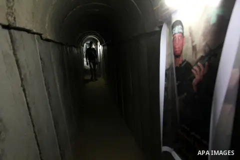 Palestinians walk inside a tunnel used for military exercises during a weapon exhibition at a Hamas-run youth summer camp, in Gaza City, on July 21, 2016. Photo by Ashraf Amra