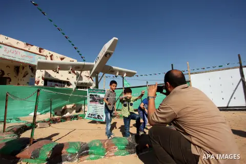 Palestinians take a photo next to Hamas drone "Ababil" during a weapon exhibition at a Hamas-run youth summer camp, in Gaza City, on July 21, 2016. Photo by Ashraf Amra