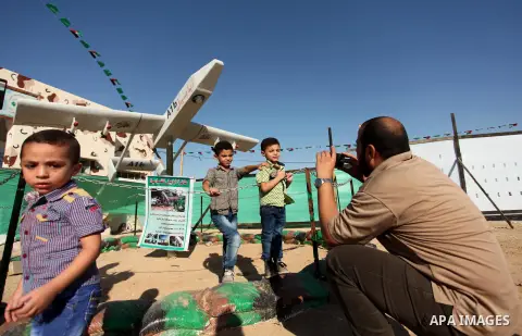 Palestinians take a photo next to Hamas drone "Ababil" during a weapon exhibition at a Hamas-run youth summer camp, in Gaza City, on July 21, 2016. Photo by Ashraf Amra