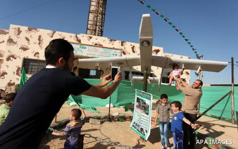 Palestinians take a photo next to Hamas drone "Ababil" during a weapon exhibition at a Hamas-run youth summer camp, in Gaza City, on July 21, 2016. Photo by Ashraf Amra