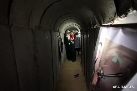 A Palestinian woman walks inside a tunnel used for military exercises during a weapon exhibition at a Hamas-run youth summer camp, in Gaza City, on July 21, 2016. Photo by Ashraf Amra