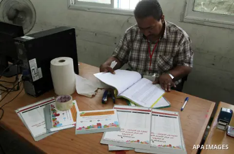 Palestinians from Central Elections Commission (CEO) work at Voter registration centers in Rafah in the southern Gaza strip on July 23, 2016. The Palestinian Central Elections Commission (CEO) announced Saturday that vot...