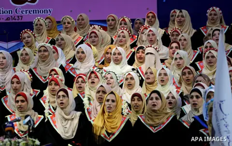Palestinian students participate in their graduation ceremony at the Islamic University in Gaza city on July 23, 2016. Photo by Mohammed Asad