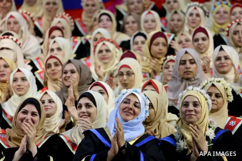 Palestinian students participate in their graduation ceremony at the Islamic University in Gaza city on July 23, 2016. Photo by Mohammed Asad