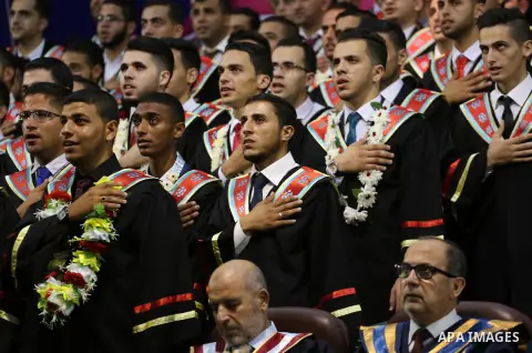 Palestinian students participate in their graduation ceremony at the Islamic University in Gaza city on July 23, 2016. Photo by Mohammed Asad