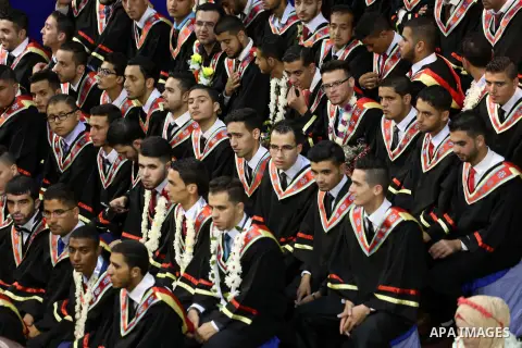 Palestinian students participate in their graduation ceremony at the Islamic University in Gaza city on July 23, 2016. Photo by Mohammed Asad