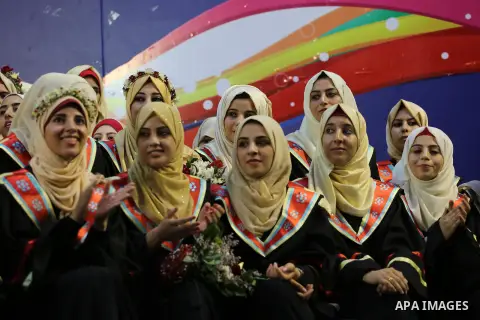 Palestinian students participate in their graduation ceremony at the Islamic University in Gaza city on July 23, 2016. Photo by Mohammed Asad