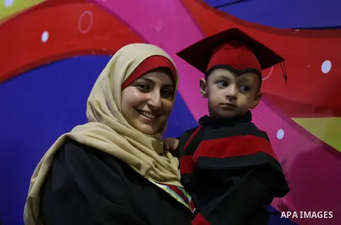 Palestinian students participate in their graduation ceremony at the Islamic University in Gaza city on July 23, 2016. Photo by Mohammed Asad
