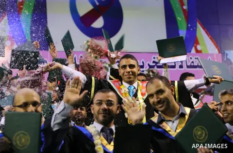 Palestinian students participate in their graduation ceremony at the Islamic University in Gaza city on July 23, 2016. Photo by Mohammed Asad