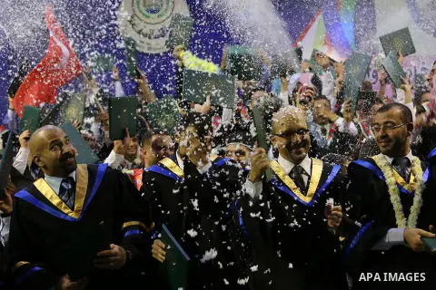 Palestinian students participate in their graduation ceremony at the Islamic University in Gaza city on July 23, 2016. Photo by Mohammed Asad