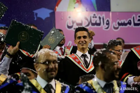 Palestinian students participate in their graduation ceremony at the Islamic University in Gaza city on July 23, 2016. Photo by Mohammed Asad