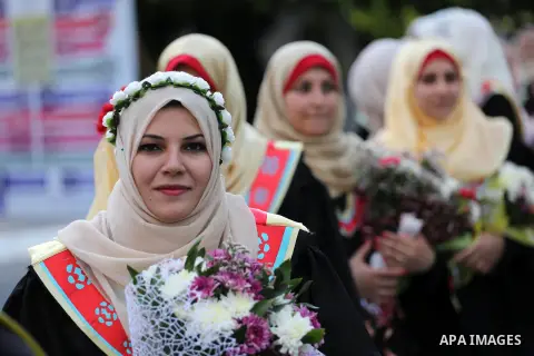 Palestinian students participate in their graduation ceremony at the Islamic University in Gaza city on July 23, 2016. Photo by Mohammed Asad