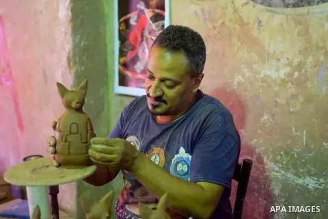 An Egyptian man works at a pottery workshop in Cairo, on July 24, 2016. Pottery is an ancient and traditional craft in Egypt. Local workshops usually produce products such as bowls, pitchers, flower pots, and vases. Phot...