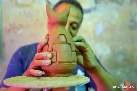 An Egyptian man works at a pottery workshop in Cairo, on July 24, 2016. Pottery is an ancient and traditional craft in Egypt. Local workshops usually produce products such as bowls, pitchers, flower pots, and vases. Phot...