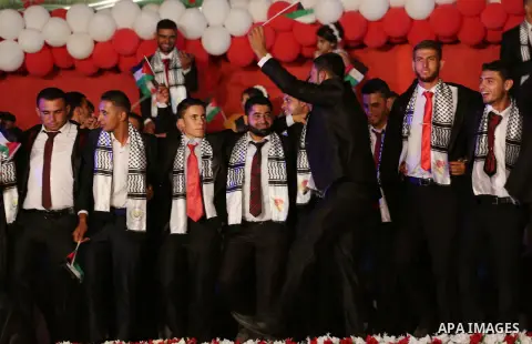 Palestinian grooms take part during a mass wedding for 340 couples organized by Hamas movement in Beit Lahiya town in the northern Gaza Strip July 24, 2016. Photo by Mohammed Asad