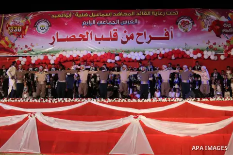 Palestinian grooms take part during a mass wedding for 340 couples organized by Hamas movement in Beit Lahiya town in the northern Gaza Strip July 24, 2016. Photo by Mohammed Asad