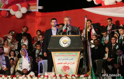 Senior Hamas leader Ismail Haniyeh speaks during a mass wedding for 340 couples organized by Hamas movement in Beit Lahiya town in the northern Gaza Strip July 24, 2016. Photo by Mohammed Asad