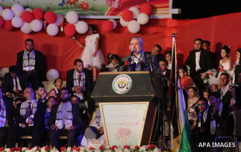 Senior Hamas leader Ismail Haniyeh speaks during a mass wedding for 340 couples organized by Hamas movement in Beit Lahiya town in the northern Gaza Strip July 24, 2016. Photo by Mohammed Asad