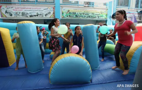 Palestinian schoolgirls enjoy as part of the activities proposed during a summer camp organised by the United Nations on July 25, 2016 in Gaza City. Photo by Ashraf Amra