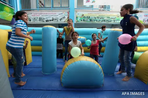 Palestinian schoolgirls enjoy as part of the activities proposed during a summer camp organised by the United Nations on July 25, 2016 in Gaza City. Photo by Ashraf Amra
