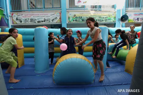 Palestinian schoolgirls enjoy as part of the activities proposed during a summer camp organised by the United Nations on July 25, 2016 in Gaza City. Photo by Ashraf Amra