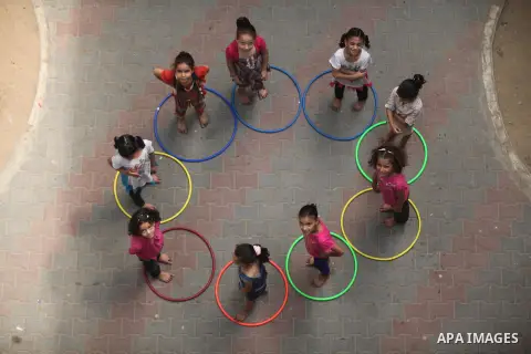 Palestinian schoolgirls enjoy as part of the activities proposed during a summer camp organised by the United Nations on July 25, 2016 in Gaza City. Photo by Ashraf Amra