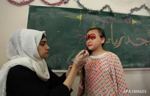 Palestinian schoolgirls enjoy as part of the activities proposed during a summer camp organised by the United Nations on July 25, 2016 in Gaza City. Photo by Ashraf Amra