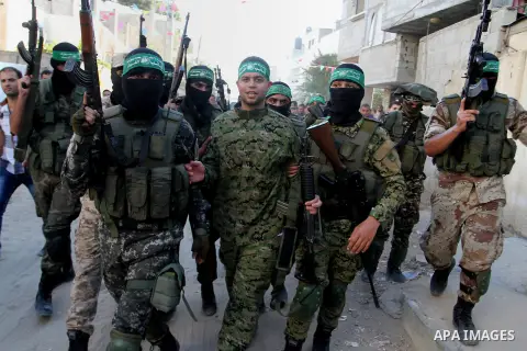 Freed Palestinian prisoner Mohammed al-Bashiti, who served 12 years in an Israeli jail after he was convicted of being a member of Hamas's armed wing is welcomed by Hamas militants in Rafah in the southern Gaza Strip, Ju...