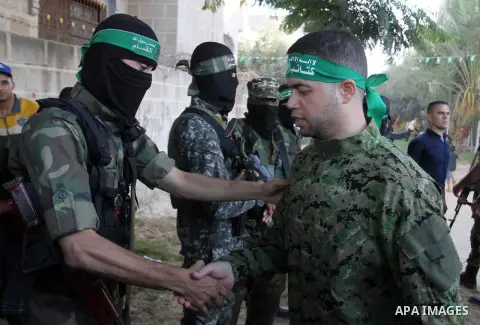 Freed Palestinian prisoner Mohammed al-Bashiti, who served 12 years in an Israeli jail after he was convicted of being a member of Hamas's armed wing is welcomed by Hamas militants in Rafah in the southern Gaza Strip, Ju...