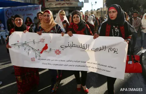 Palestinians take part during a ceremony of Palestinian Traditional Dress and Heritage Day in the West Bank city of Ramallah, on July 25, 2016. Photo by Shadi Hatem
