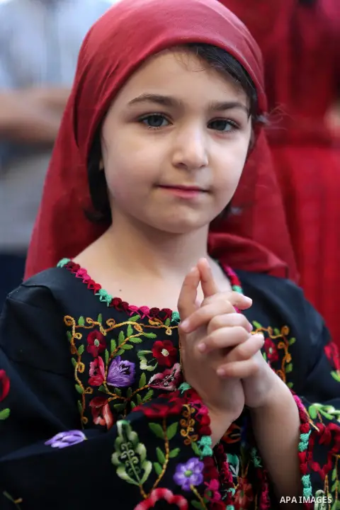 A Palestinian girl takes part during a ceremony of Palestinian Traditional Dress and Heritage Day in the West Bank city of Ramallah, on July 25, 2016. Photo by Shadi Hatem