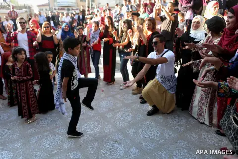 Palestinians perform a traditional dance during a ceremony of Palestinian Traditional Dress and Heritage Day in the West Bank city of Ramallah, on July 25, 2016. Photo by Shadi Hatem