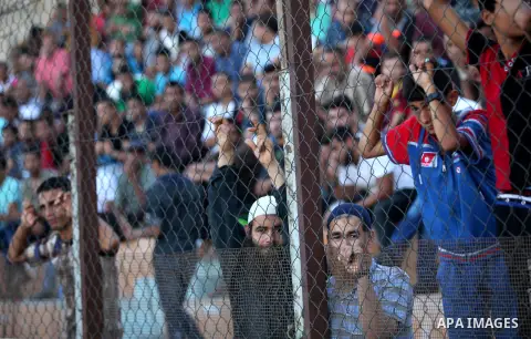A Palestinian spectator watches the first leg of the Palestine Cup final soccer match between Gaza Strip's Khan Younis Youth and Hebron's Al-Ahly at al-Yarmouk stadium in Gaza City July 26, 2016. Photo by Ashraf Amra