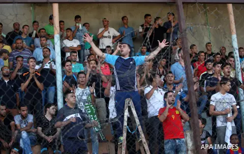 Palestinian spectators watch the first leg of the Palestine Cup final soccer match between Gaza Strip's Khan Younis Youth and Hebron's Al-Ahly at al-Yarmouk stadium in Gaza City July 26, 2016. Photo by Ashraf Amra