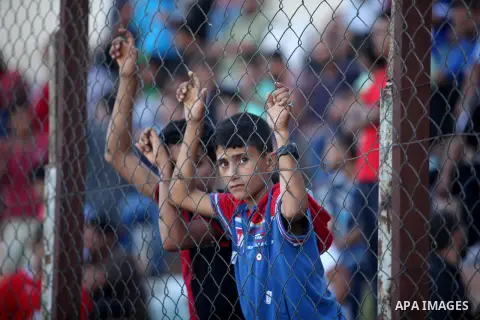 A Palestinian spectator watches the first leg of the Palestine Cup final soccer match between Gaza Strip's Khan Younis Youth and Hebron's Al-Ahly at al-Yarmouk stadium in Gaza City July 26, 2016. Photo by Ashraf Amra