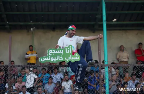 Palestinian spectators watch the first leg of the Palestine Cup final soccer match between Gaza Strip's Khan Younis Youth and Hebron's Al-Ahly at al-Yarmouk stadium in Gaza City July 26, 2016. Photo by Ashraf Amra