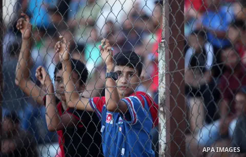 Palestinian spectators watch the first leg of the Palestine Cup final soccer match between Gaza Strip's Khan Younis Youth and Hebron's Al-Ahly at al-Yarmouk stadium in Gaza City July 26, 2016. Photo by Ashraf Amra