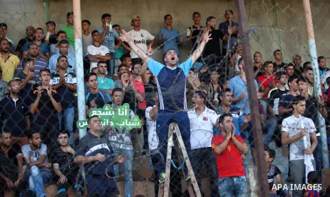 Palestinian spectators watch the first leg of the Palestine Cup final soccer match between Gaza Strip's Khan Younis Youth and Hebron's Al-Ahly at al-Yarmouk stadium in Gaza City July 26, 2016. Photo by Ashraf Amra