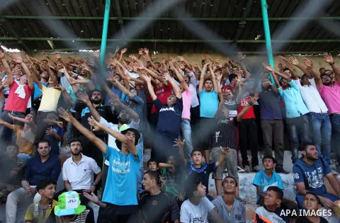 Palestinian spectators watch the first leg of the Palestine Cup final soccer match between Gaza Strip's Khan Younis Youth and Hebron's Al-Ahly at al-Yarmouk stadium in Gaza City July 26, 2016. Photo by Ashraf Amra