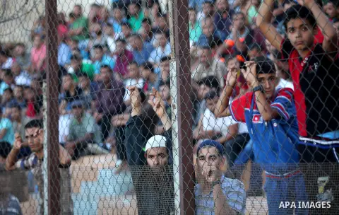 A Palestinian spectator watches the first leg of the Palestine Cup final soccer match between Gaza Strip's Khan Younis Youth and Hebron's Al-Ahly at al-Yarmouk stadium in Gaza City July 26, 2016. Photo by Ashraf Amra