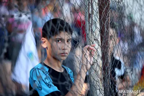 A Palestinian spectator watches the first leg of the Palestine Cup final soccer match between Gaza Strip's Khan Younis Youth and Hebron's Al-Ahly at al-Yarmouk stadium in Gaza City July 26, 2016. Photo by Ashraf Amra